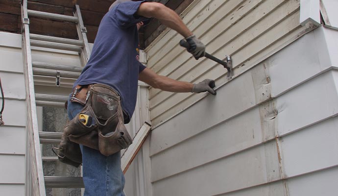 Expert team installing siding.